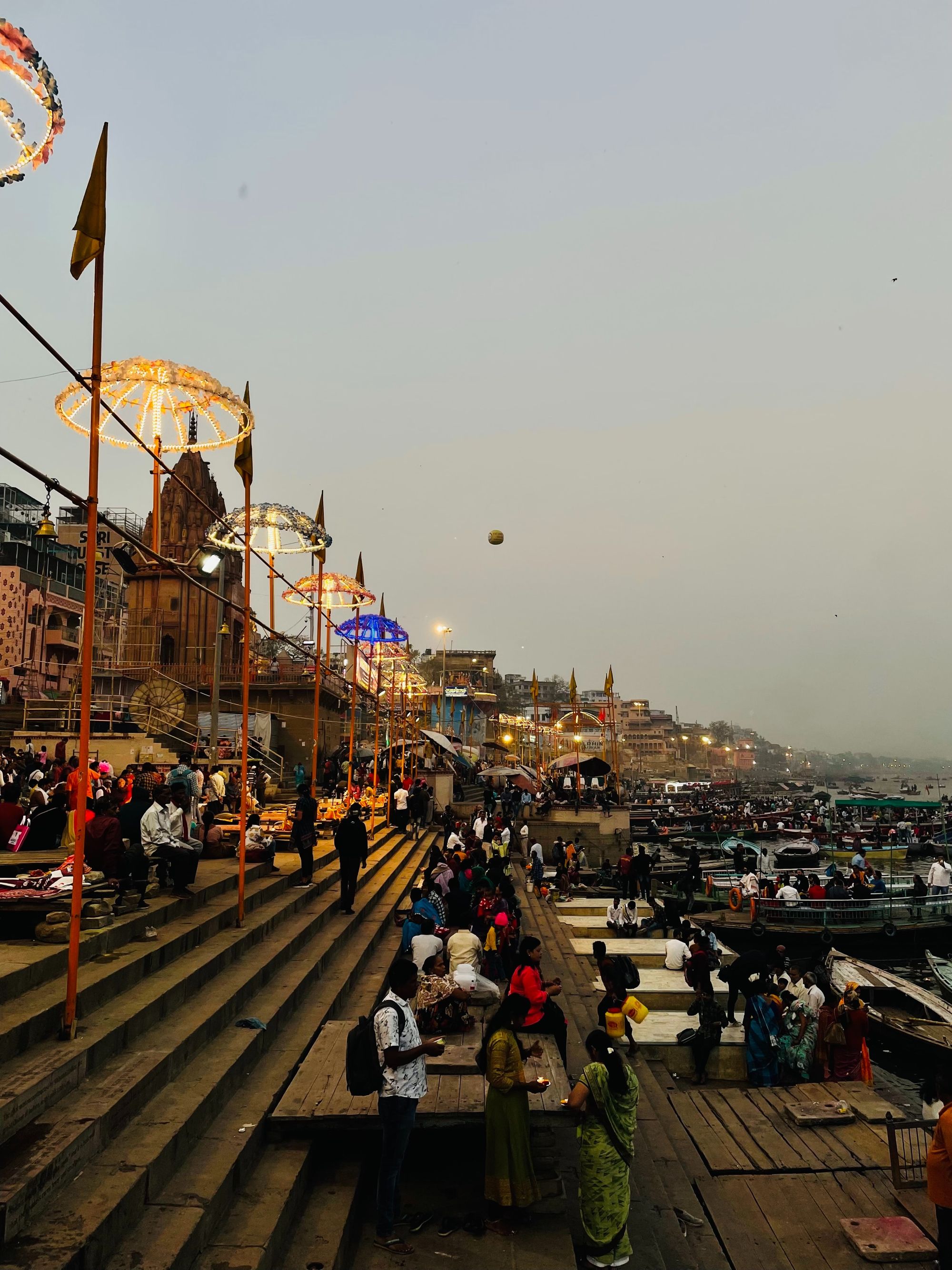 Varanasi ghats at evening with golden light and boats on the Ganga