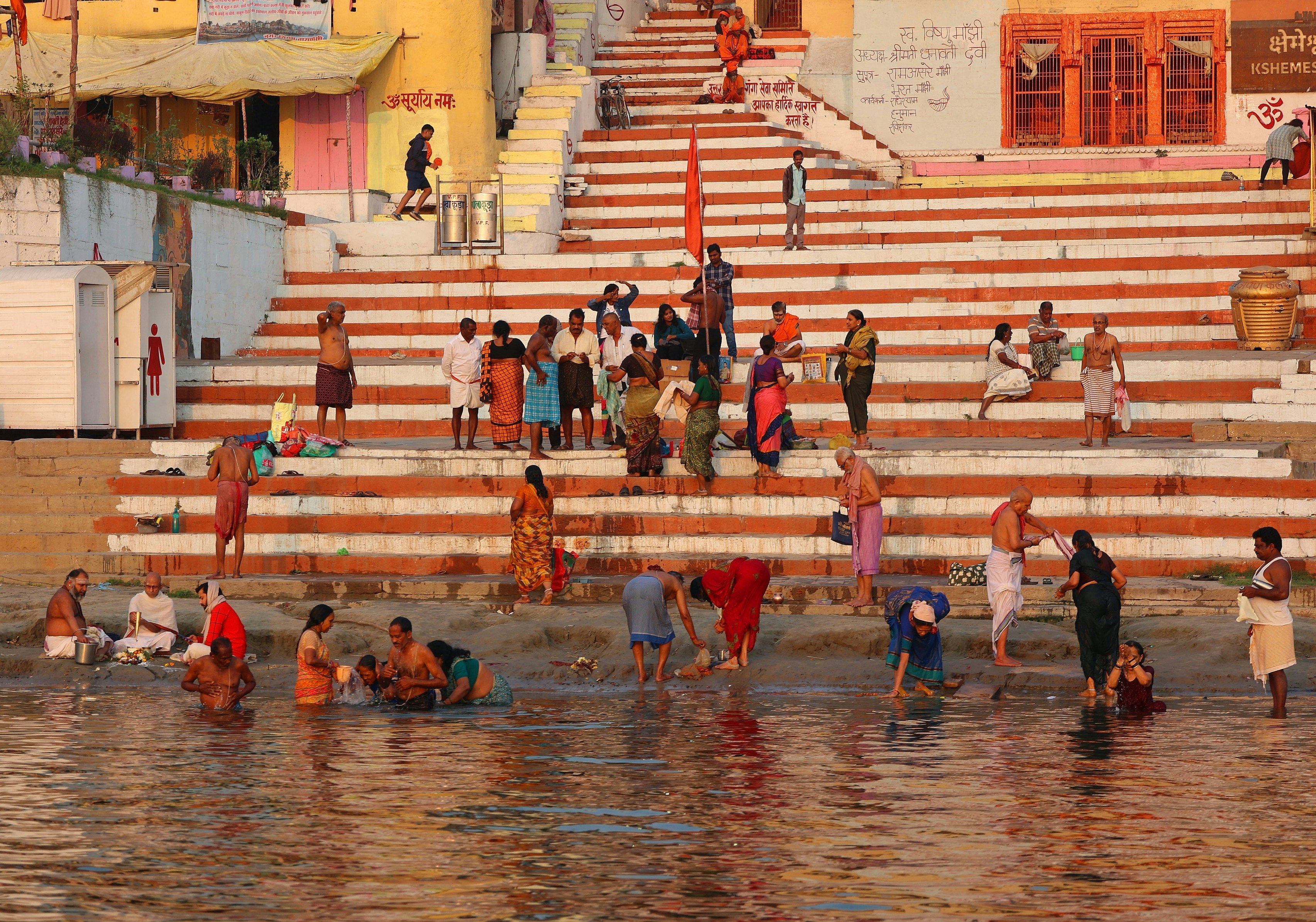 Sunrise over the Ganges at Varanasi, with boats silhouetted against golden light and the ghats in the background